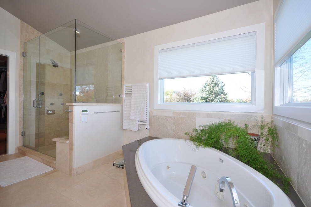 Photo of an expansive modern master bathroom in Philadelphia with a vessel sink, flat-panel cabinets, light wood cabinets, quartzite benchtops, a corner tub, an alcove shower, a one-piece toilet, beige tile, stone tile, beige walls and marble floors.