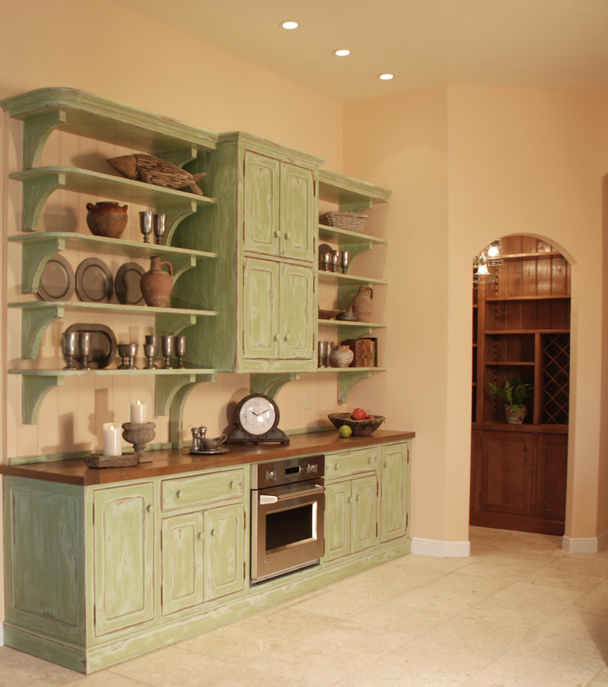 Inspiration for a large rustic u-shaped ceramic tile and beige floor enclosed kitchen remodel in Miami with beaded inset cabinets, green cabinets, an island, solid surface countertops, brown backsplash, wood backsplash, stainless steel appliances and a farmhouse sink