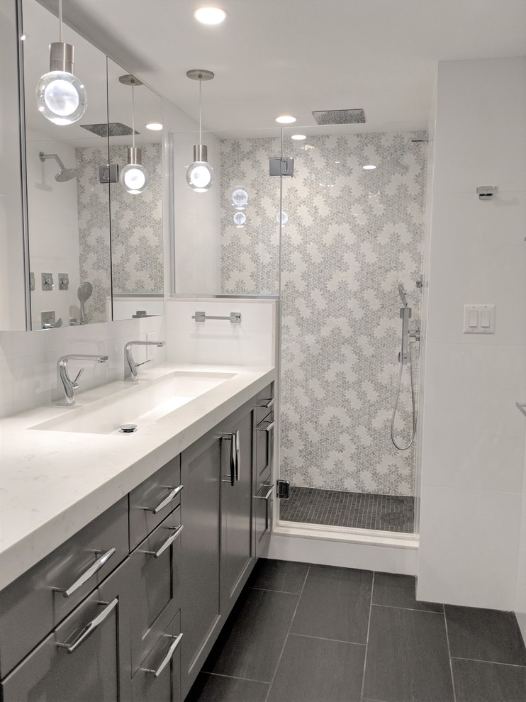 Photo of a modern master bathroom in Boston with recessed-panel cabinets, grey cabinets, white tile, subway tile, white walls, a trough sink, quartzite benchtops, a hinged shower door and white benchtops.