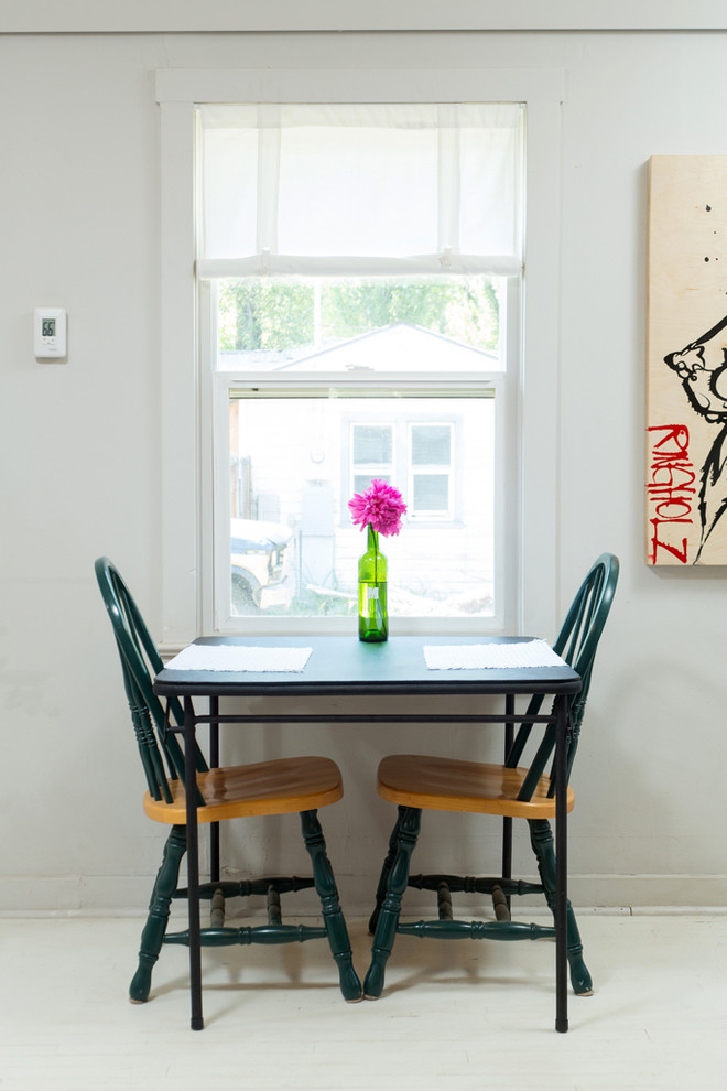 Photo of a small traditional dining room in Other with white walls and painted wood floors.