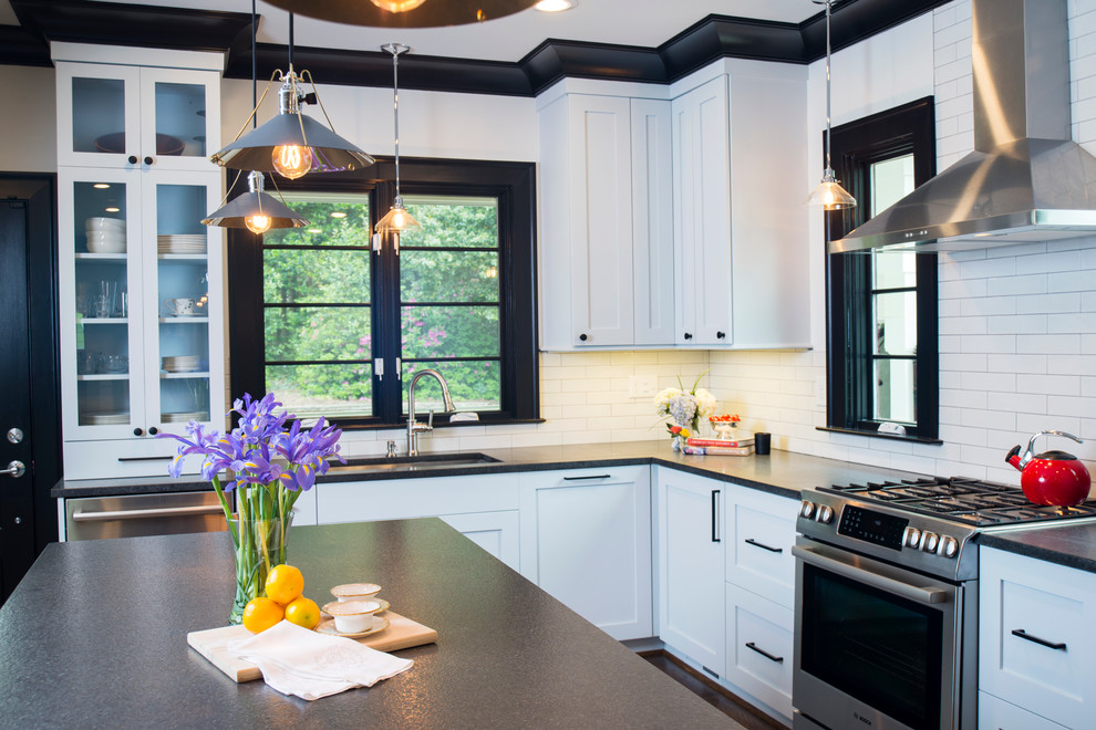 Large arts and crafts l-shaped medium tone wood floor eat-in kitchen photo in Atlanta with an undermount sink, shaker cabinets, white cabinets, soapstone countertops, white backsplash, subway tile backsplash, stainless steel appliances and an island