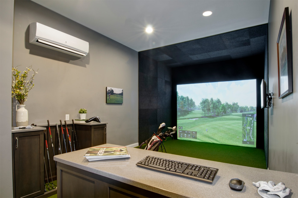 Mid-sized enclosed home theatre in Columbus with grey walls, a projector screen and green floor.