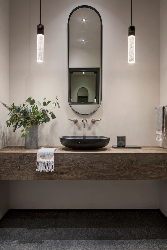 Modern Ski Home - Mountain style mosaic tile floor powder room photo with a vessel sink, wood countertops and a floating vanity