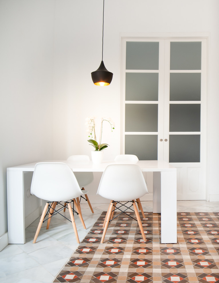 Small contemporary separate dining room in Malaga with white walls, ceramic floors and no fireplace.
