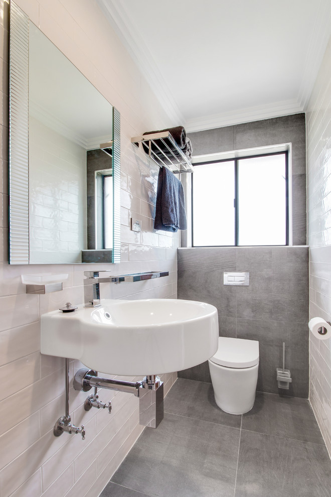 Photo of a small modern 3/4 bathroom in Adelaide with a double shower, a two-piece toilet, white tile, subway tile, cement tiles, a wall-mount sink, grey floor and an open shower.
