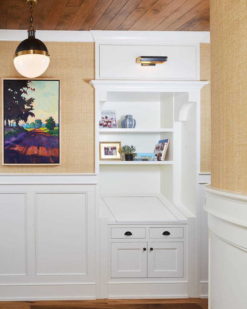 This is an example of a mid-sized beach style hallway with beige walls, medium hardwood floors and brown floor.