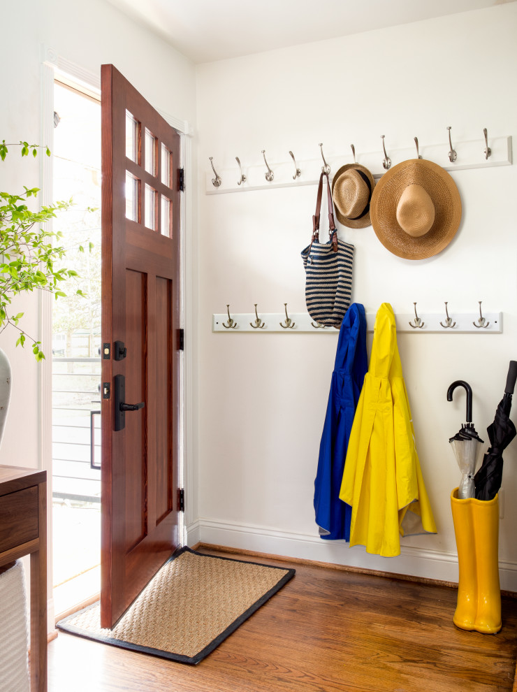 Inspiration for a transitional medium tone wood floor and brown floor single front door remodel in DC Metro with white walls and a medium wood front door