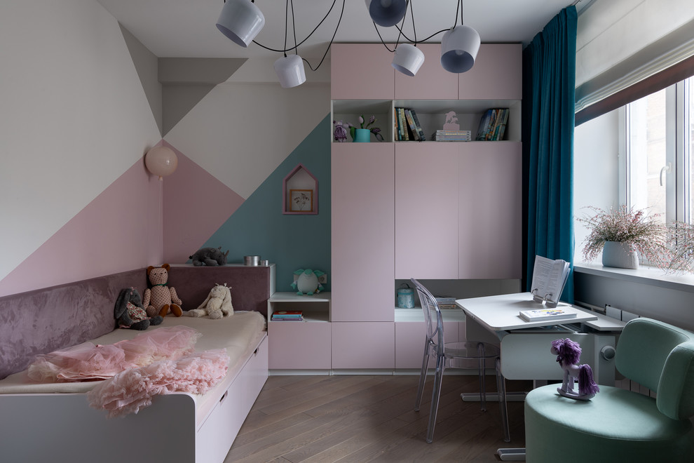 Inspiration for a contemporary kids' room for girls in Moscow with multi-coloured walls, medium hardwood floors and beige floor.