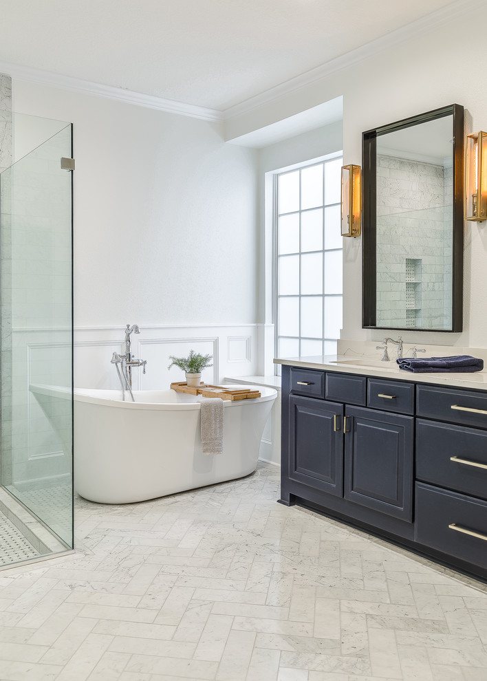 Transitional master bathroom in Orlando with raised-panel cabinets, blue cabinets, a freestanding tub, white walls, white floor and white benchtops.