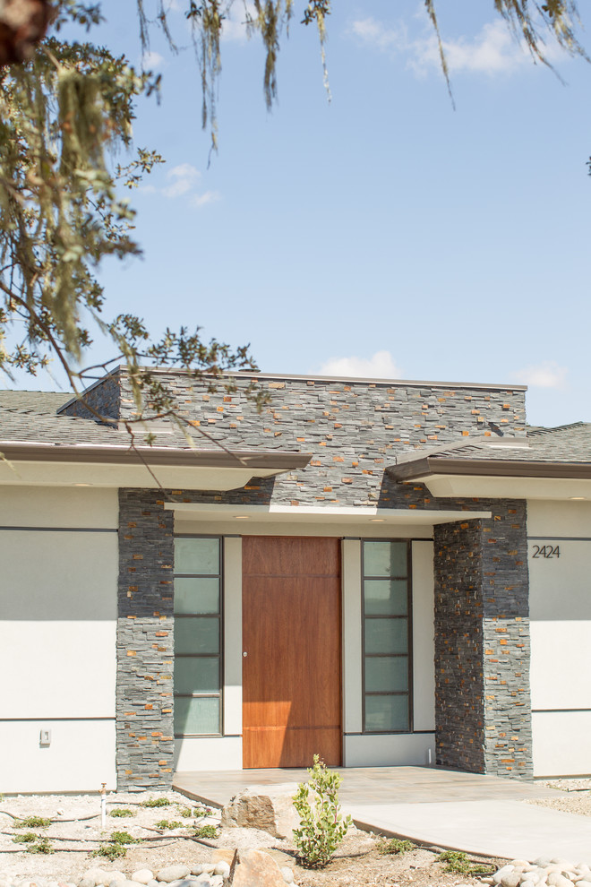 This is an example of a large contemporary one-storey grey exterior in San Luis Obispo with mixed siding.
