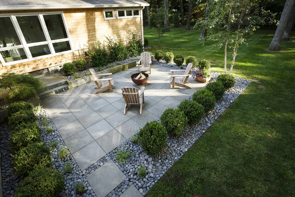 Photo of a mid-sized contemporary front yard patio in Providence with concrete pavers and no cover.