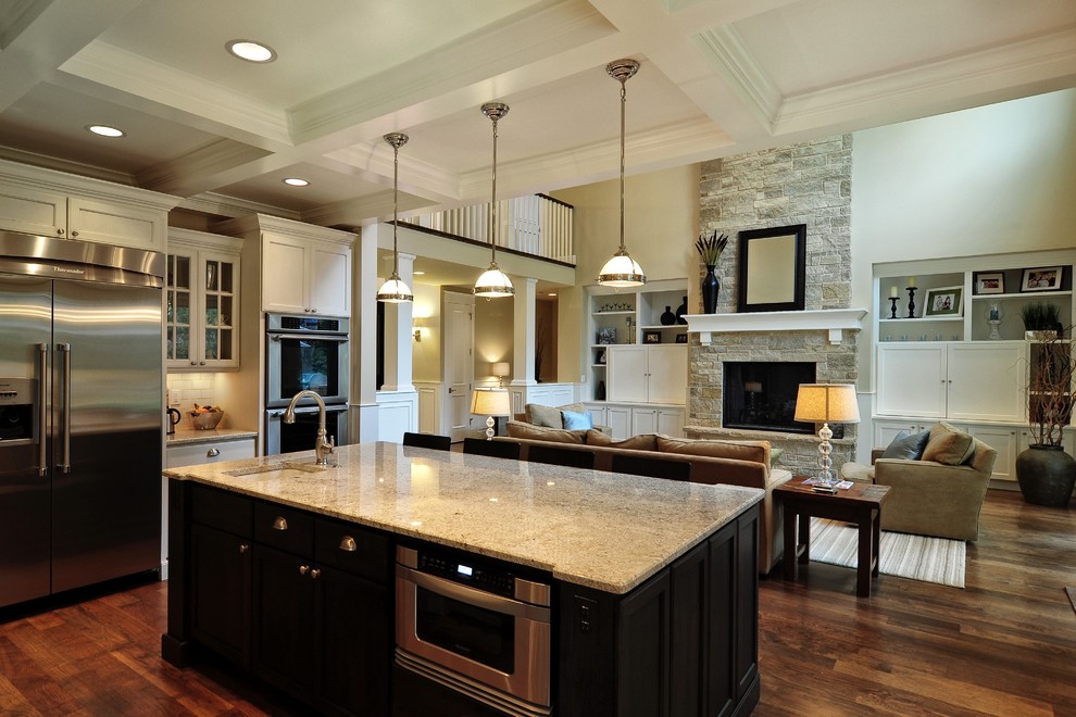 Inspiration for a mid-sized traditional open plan kitchen in Denver with shaker cabinets, white cabinets, granite benchtops, white splashback, subway tile splashback, stainless steel appliances, medium hardwood floors and with island.