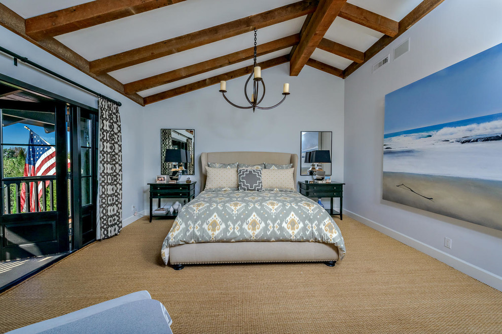 Inspiration for a mid-sized beach style guest bedroom in Orange County with white walls, carpet, no fireplace and beige floor.