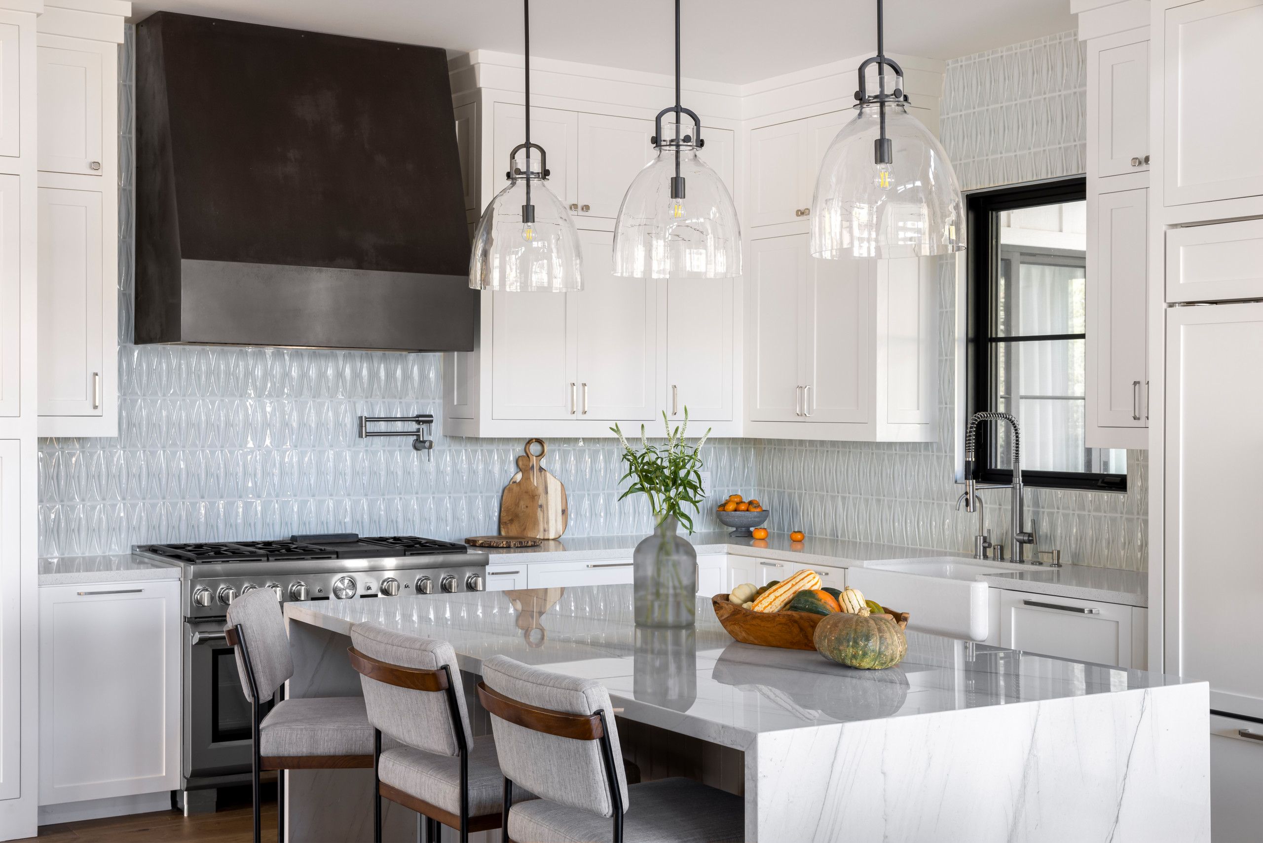 Example of a huge country l-shaped medium tone wood floor and brown floor open concept kitchen design in San Francisco with a farmhouse sink, shaker cabinets, white cabinets, marble countertops, blue