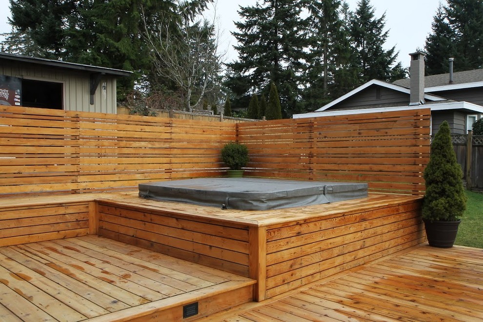 Water fountain deck - large rustic backyard water fountain deck idea in Vancouver with no cover