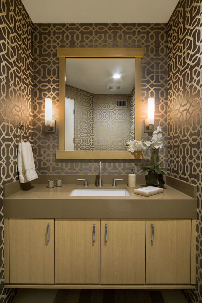 This is an example of a small modern powder room in Seattle with flat-panel cabinets, light wood cabinets, multi-coloured tile and mosaic tile.