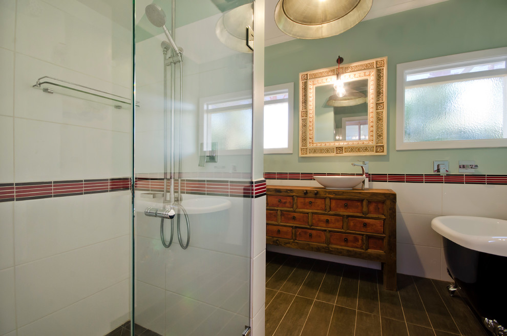 Small asian master bathroom in Melbourne with a vessel sink, furniture-like cabinets, medium wood cabinets, wood benchtops, a claw-foot tub, an alcove shower, a one-piece toilet, red tile, ceramic tile, green walls, ceramic floors, brown floor and a hinged shower door.