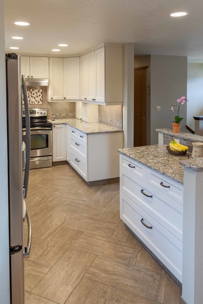 Inspiration for a mid-sized transitional u-shaped porcelain tile eat-in kitchen remodel in Seattle with an undermount sink, recessed-panel cabinets, white cabinets, quartz countertops, brown backsplash, ceramic backsplash, stainless steel appliances and no island