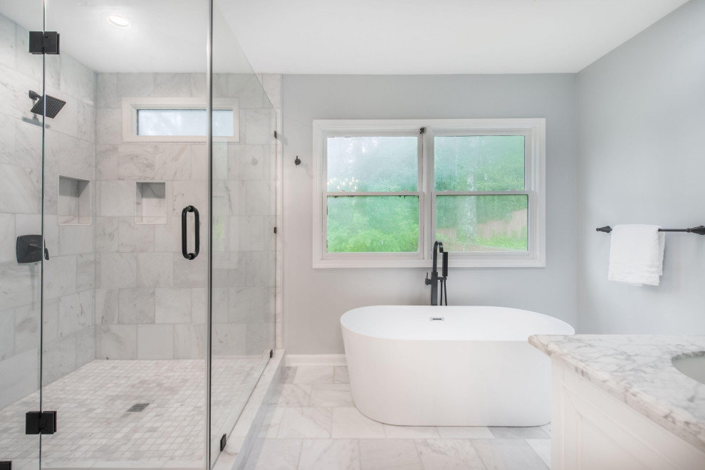 Пример оригинального дизайна: большая главная ванная комната в стиле модернизм с фасадами в стиле шейкер, белыми фасадами, раздельным унитазом, серой плиткой, каменной плиткой, серыми стенами, полом из керамогранита, серым полом, напольной тумбой, отдельно стоящей ванной, душевой комнатой, врезной раковиной, столешницей из искусственного кварца, душем с распашными дверями, серой столешницей и тумбой под две раковины