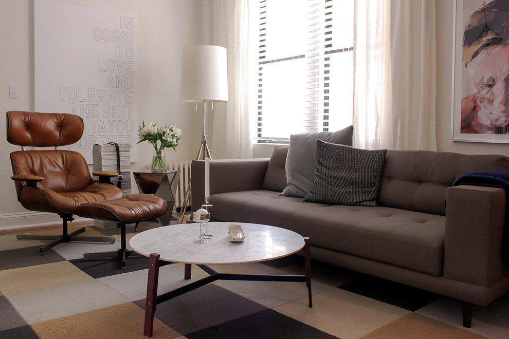 Example of a small eclectic enclosed medium tone wood floor living room design in New York with white walls and a wall-mounted tv