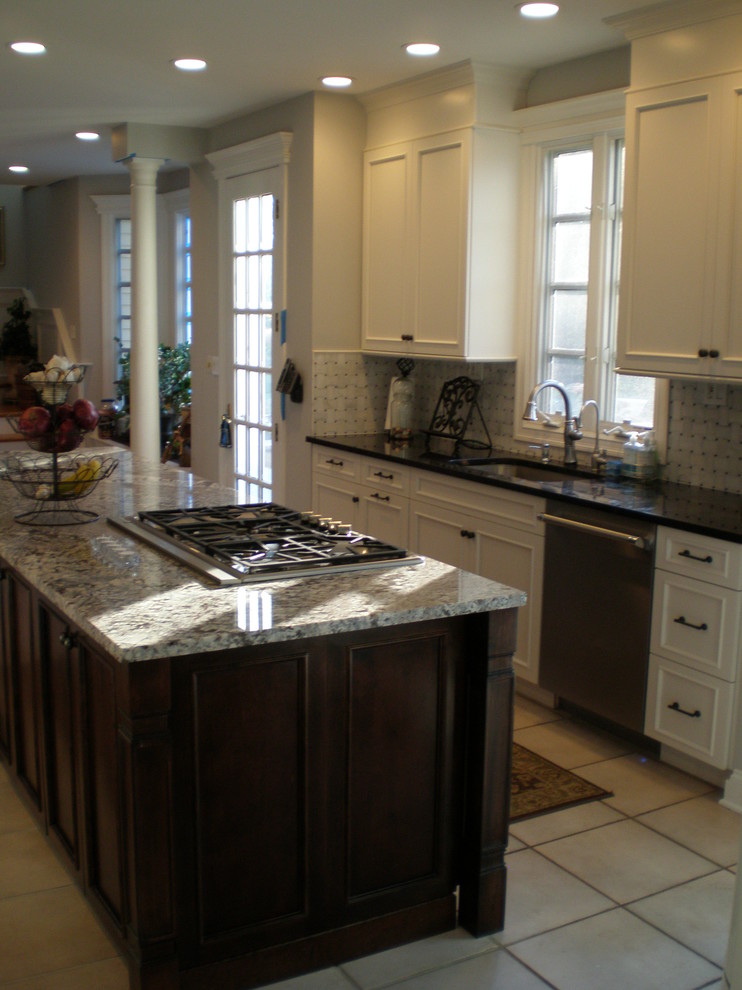 Example of a large classic single-wall ceramic tile open concept kitchen design in New York with an undermount sink, shaker cabinets, white cabinets, granite countertops, multicolored backsplash, mosaic tile backsplash, stainless steel appliances and an island