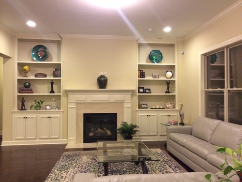 Help !!! clueless on how to decorate fireplace mantel The picture tells all. The sofa is light silvery grey. The rug is a distressed finish rug with some bottle green