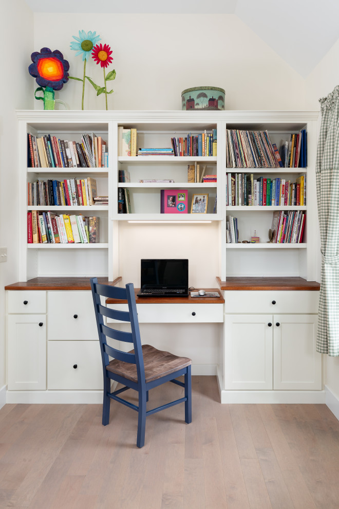 Inspiration for a small traditional craft room in Boston with white walls and a built-in desk.