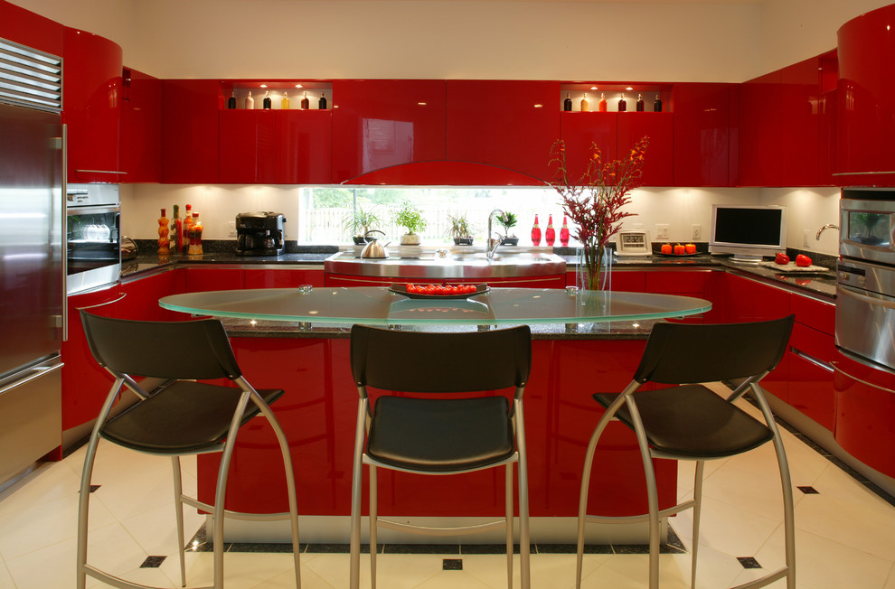 Minimalist u-shaped kitchen photo in DC Metro with flat-panel cabinets, red cabinets, white backsplash, stainless steel appliances, an island, stone slab backsplash and a double-bowl sink
