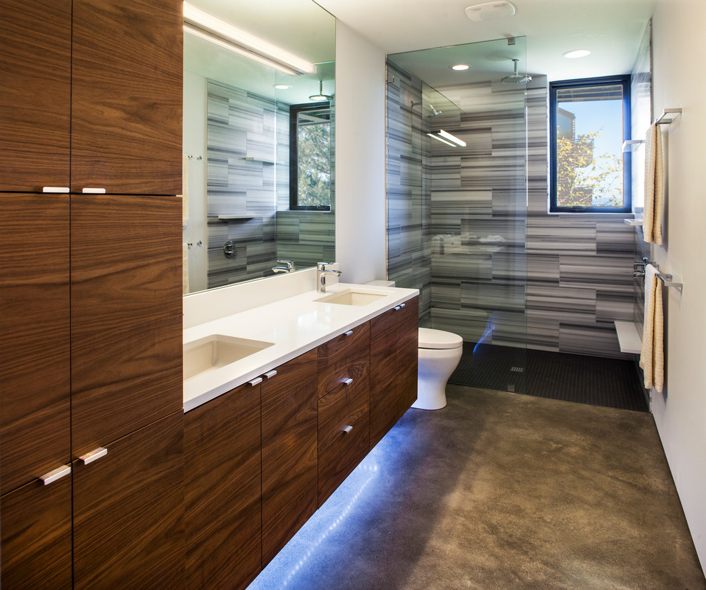 Design ideas for a mid-sized modern master bathroom in Portland with flat-panel cabinets, medium wood cabinets, an open shower, gray tile, porcelain tile, engineered quartz benchtops, a two-piece toilet, white walls, concrete floors, an undermount sink, grey floor and an open shower.