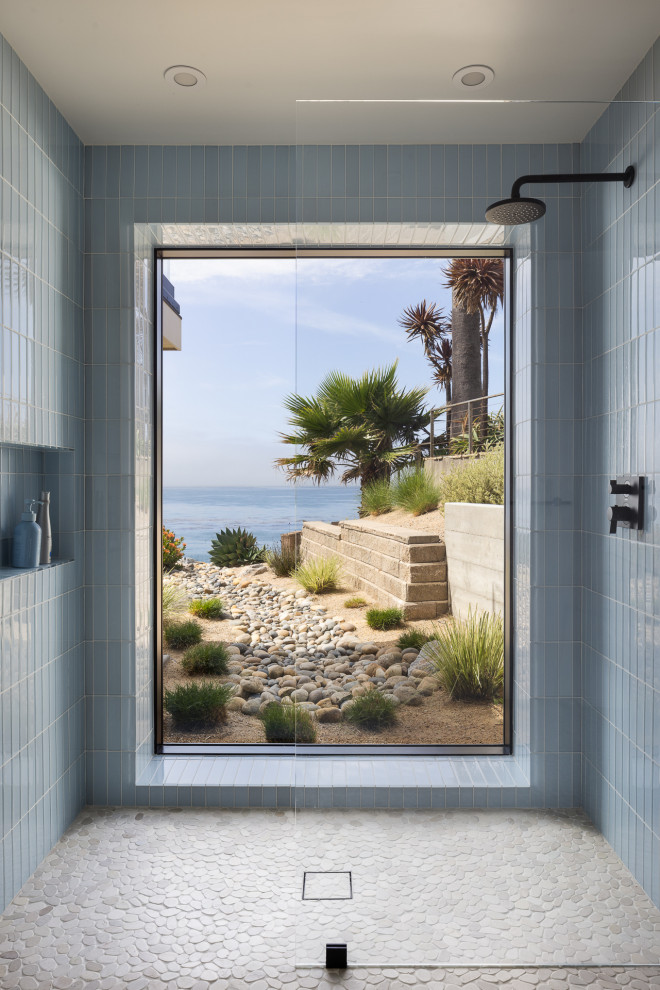 Inspiration for a contemporary blue tile pebble tile floor and gray floor alcove shower remodel in San Luis Obispo with blue walls and a niche