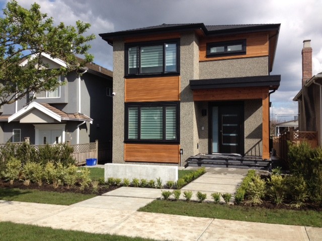 Mid-sized contemporary three-storey grey exterior in Vancouver with wood siding and a flat roof.