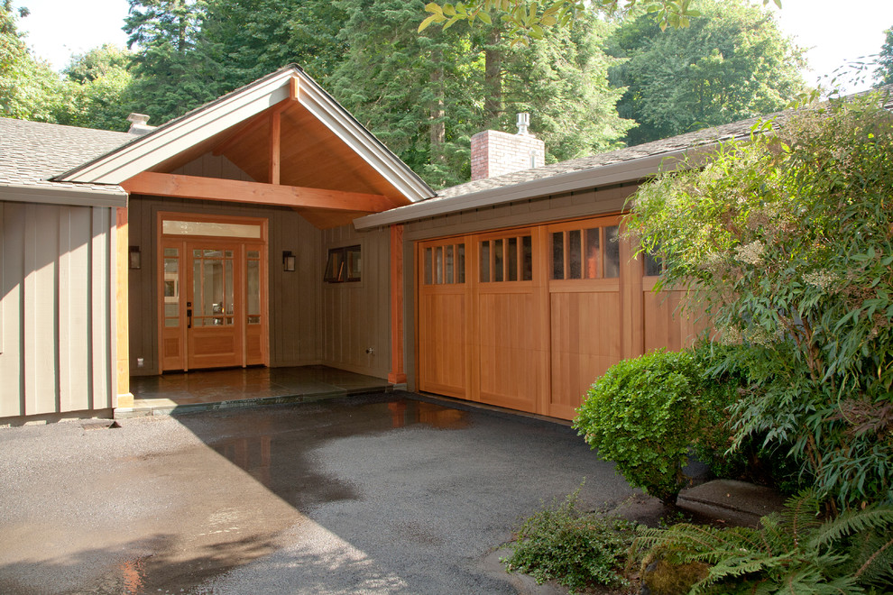 Design ideas for a large arts and crafts attached three-car garage in Portland.