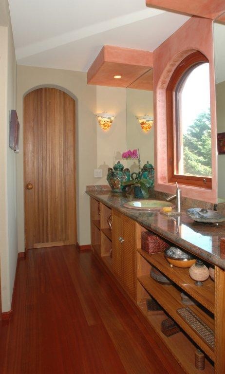 Inspiration for a large asian master bathroom in San Diego with open cabinets, medium wood cabinets, beige walls, dark hardwood floors, a drop-in sink, granite benchtops, a one-piece toilet, brown floor, an open shower, a hot tub, gray tile and stone tile.