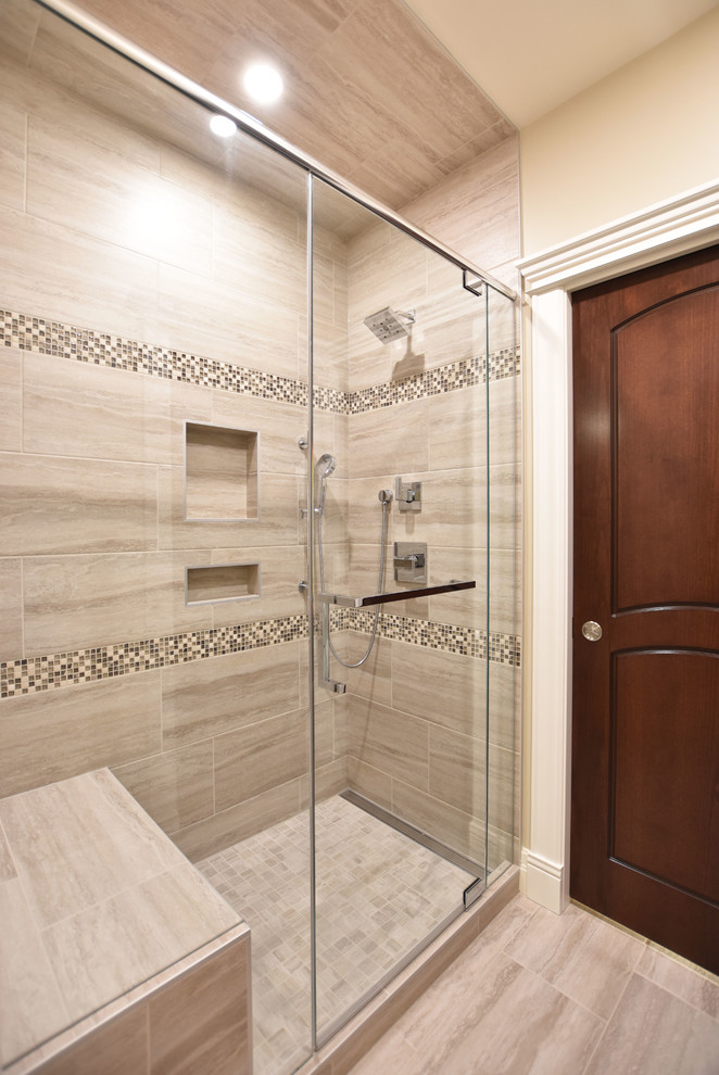 Photo of a traditional bathroom in Other with shaker cabinets, medium wood cabinets, an open shower, a two-piece toilet, multi-coloured tile, mosaic tile, beige walls, porcelain floors, an undermount sink, quartzite benchtops, grey floor, a hinged shower door and beige benchtops.