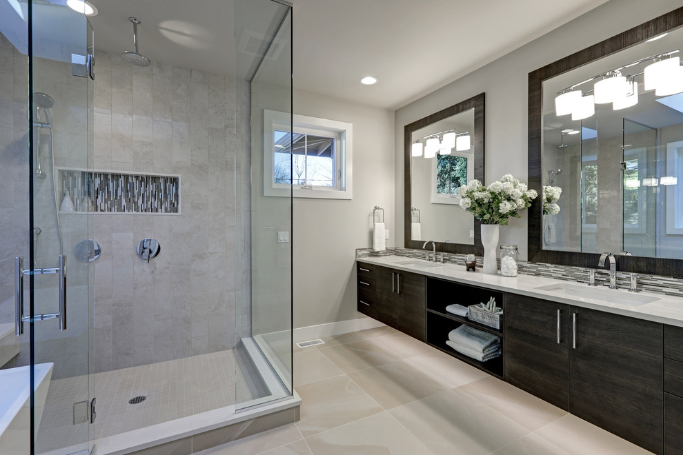 Large modern master bathroom in Chicago with dark wood cabinets, a freestanding tub, a corner shower, beige tile, ceramic tile, beige walls, a drop-in sink, beige floor, a hinged shower door, flat-panel cabinets, a one-piece toilet, ceramic floors and engineered quartz benchtops.