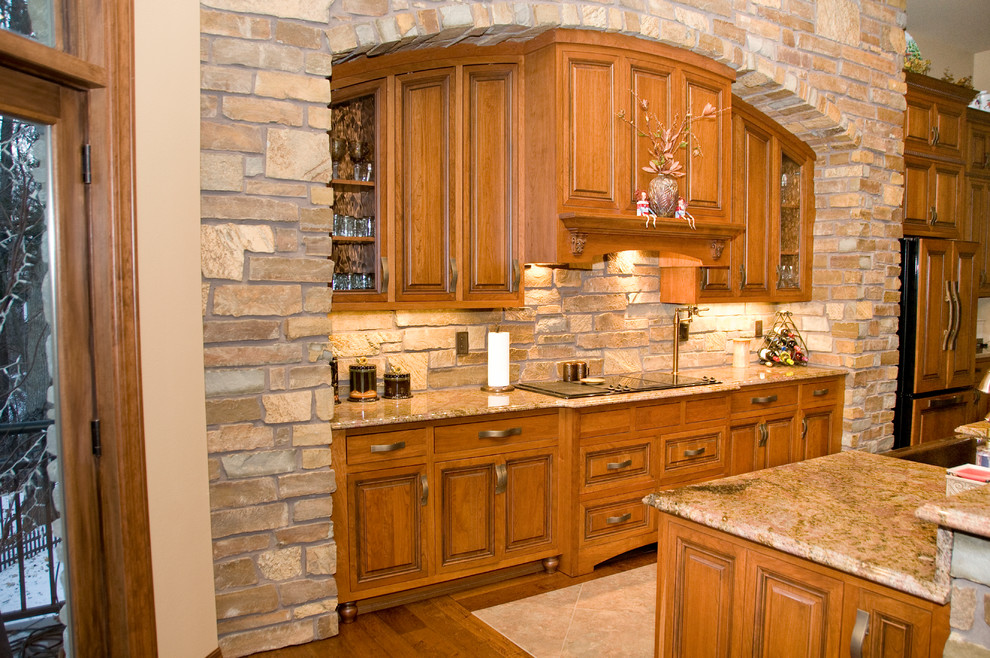 Inspiration for a large transitional l-shaped open concept kitchen remodel in Cedar Rapids with a farmhouse sink, raised-panel cabinets, medium tone wood cabinets, granite countertops, stainless steel appliances and an island