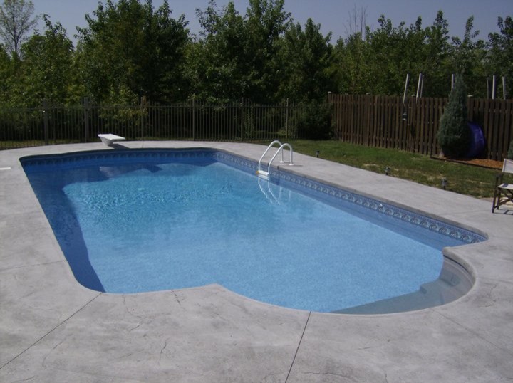Inspiration for a large backyard stone pool remodel in Toronto