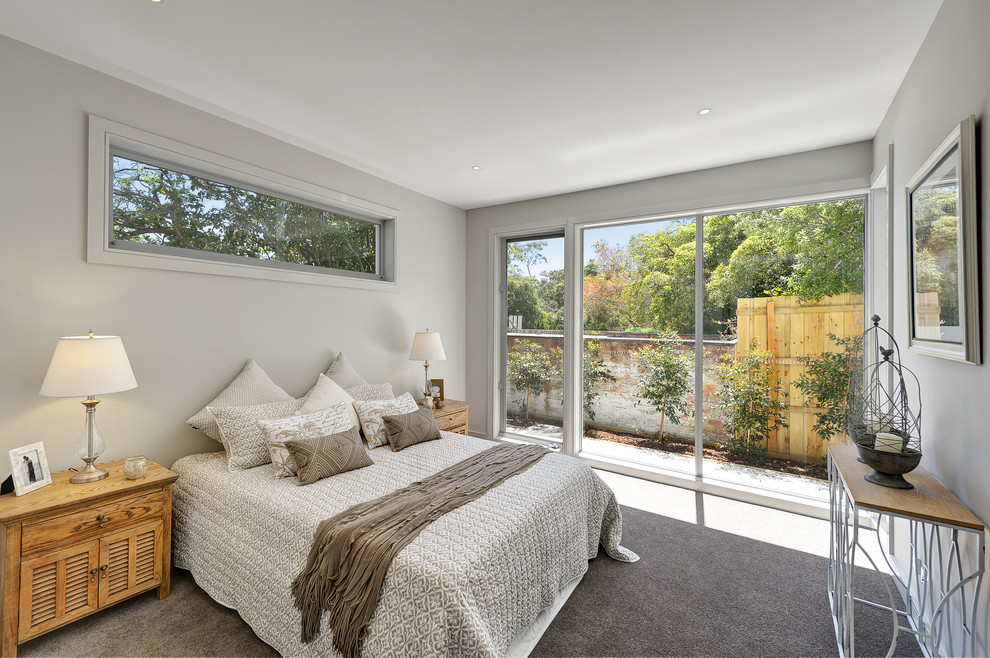 This is an example of a mid-sized contemporary guest bedroom in Melbourne with carpet and brown floor.
