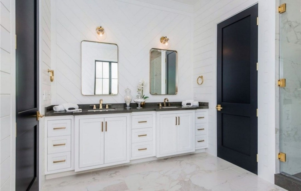 Inspiration for a mid-sized contemporary master bathroom in Los Angeles with glass-front cabinets, yellow cabinets, a one-piece toilet, gray tile, grey walls, marble floors, an integrated sink, marble benchtops, multi-coloured floor, a hinged shower door, white benchtops, a niche, a double vanity and a built-in vanity.