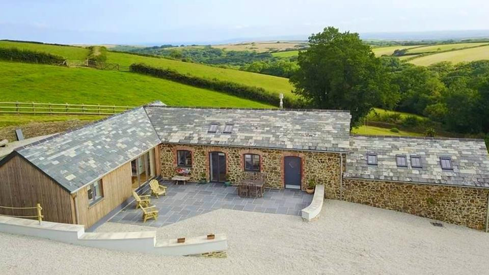 Photo of a country rear house exterior in Cornwall with stone cladding.