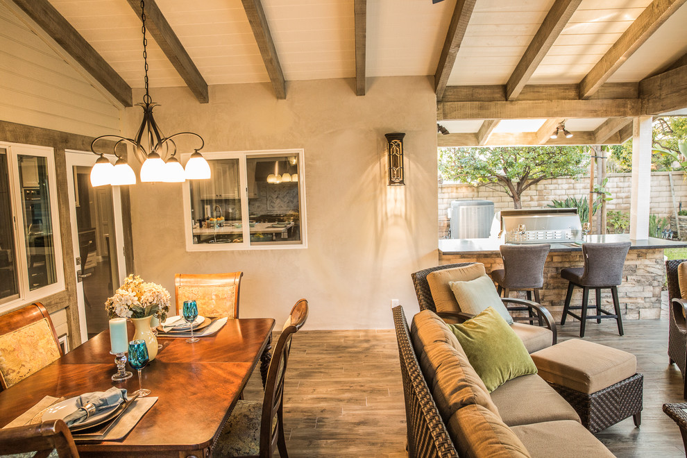 Mid-sized elegant backyard patio kitchen photo in Los Angeles with decking and a roof extension