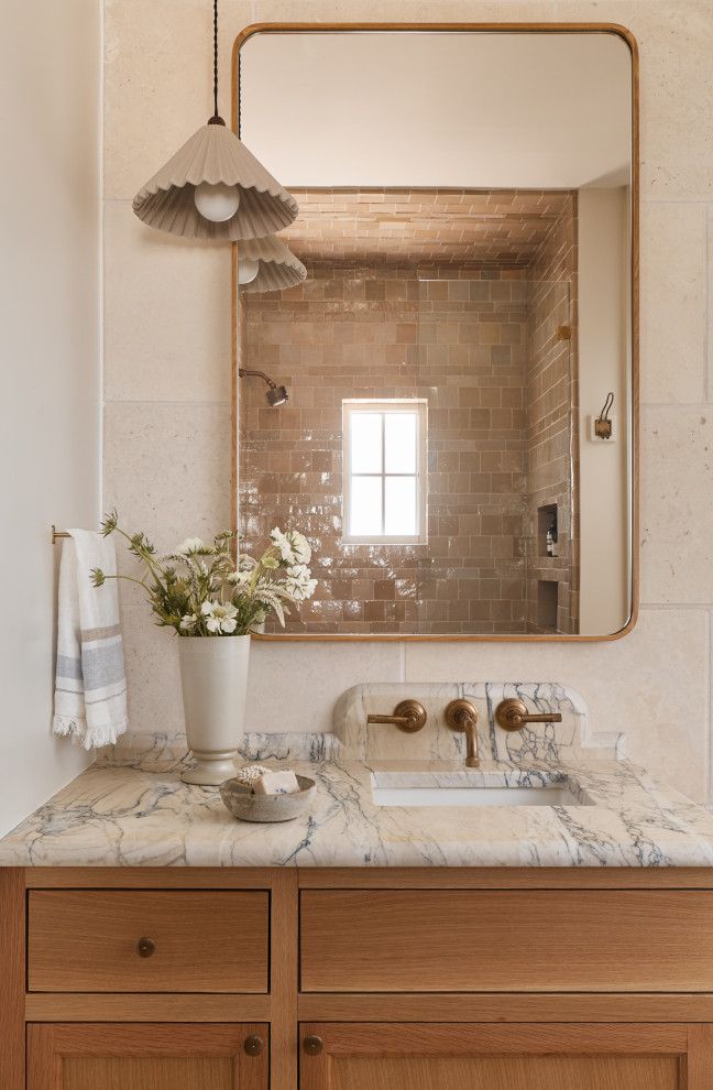 Hill Country Village Legacy Home - Inspiration for a small transitional 3/4 beige tile and terra-cotta tile single-sink shower bench remodel in Austin with flat-panel cabinets, light wood cabinets, beige walls, an undermount sink, marble countertops, a hinged shower door, white countertops and a built-in vanity
