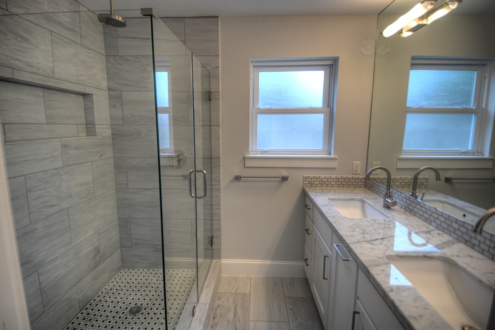 Small contemporary master bathroom in Houston with an undermount sink, recessed-panel cabinets, white cabinets, marble benchtops, a corner shower, a one-piece toilet, gray tile, stone tile, grey walls and marble floors.