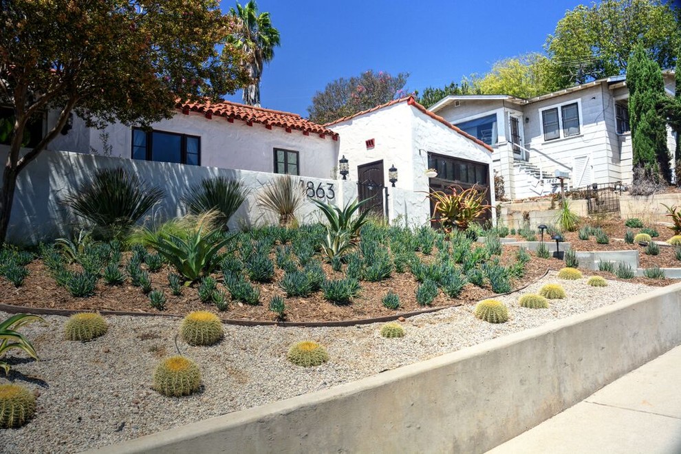 Mid-sized mediterranean front yard full sun xeriscape in Los Angeles with a garden path and gravel for spring.
