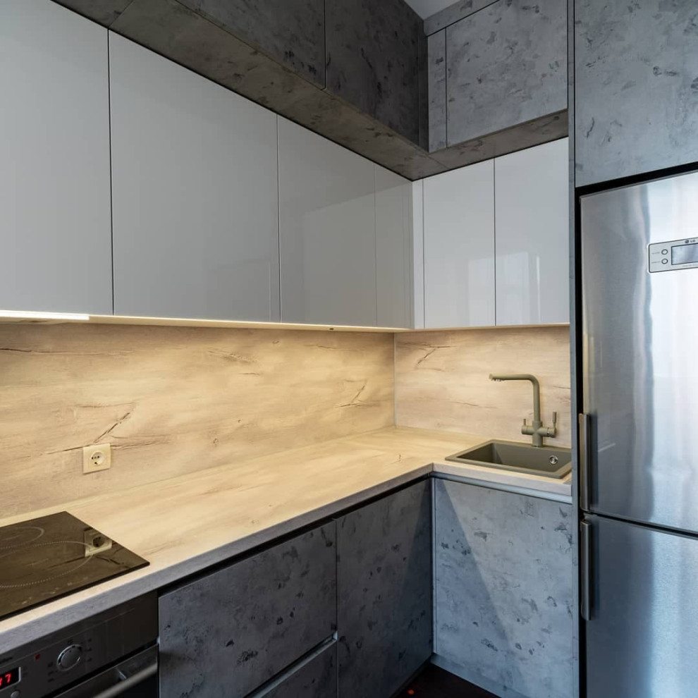 This is an example of a small industrial l-shaped open plan kitchen in Moscow with a drop-in sink, flat-panel cabinets, grey cabinets, wood benchtops, grey splashback, timber splashback, panelled appliances, linoleum floors, no island, brown floor and grey benchtop.