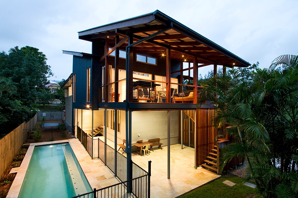 Photo of a large beach style backyard deck in Brisbane with a roof extension.