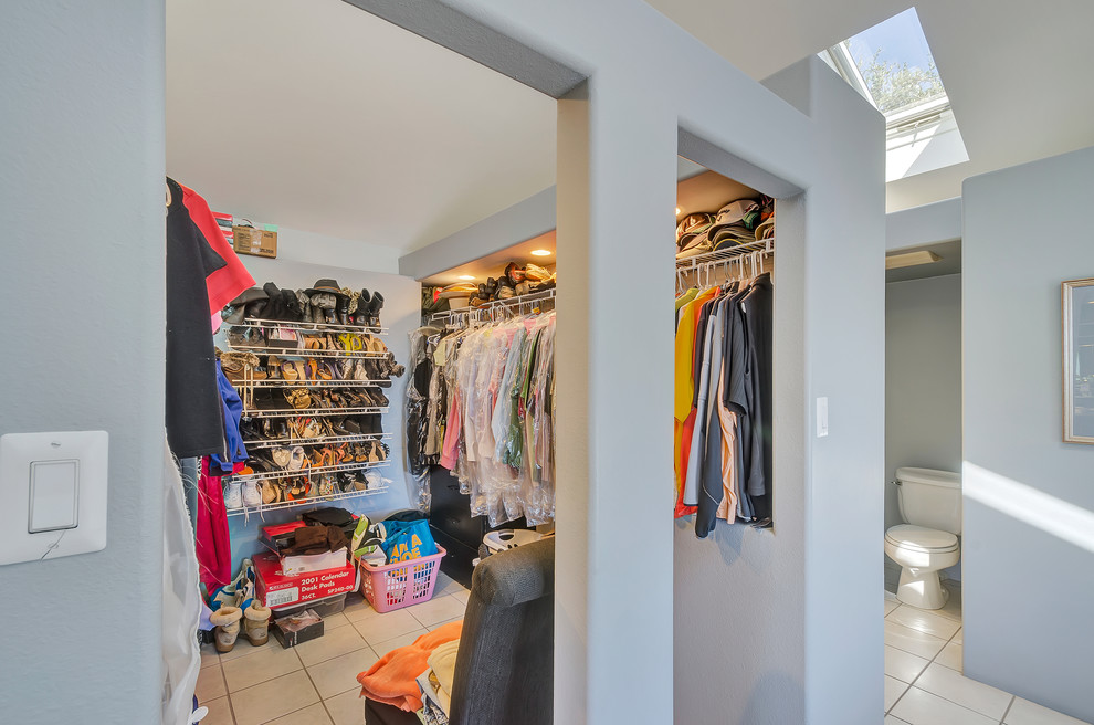 This is an example of a tropical storage and wardrobe in Miami.