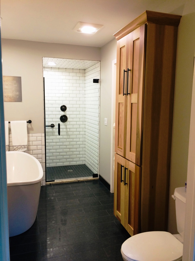 Inspiration for a rustic white tile and subway tile ceramic tile, blue floor and single-sink bathroom remodel with shaker cabinets, medium tone wood cabinets, granite countertops and beige countertops