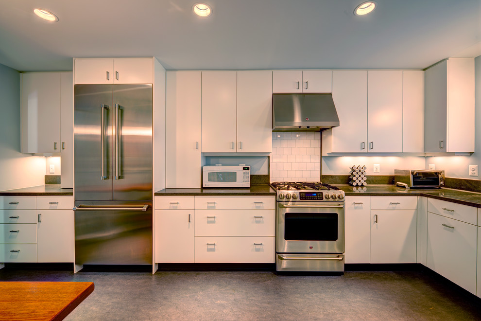 Large transitional l-shaped enclosed kitchen photo in DC Metro with white cabinets and white backsplash