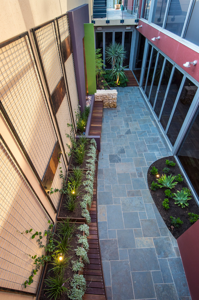 Design ideas for a small contemporary courtyard patio in Perth with decking and a container garden.